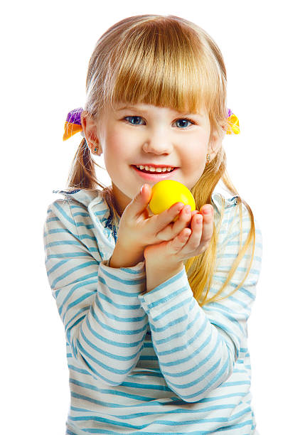 sweet little girl with yellow Easter egg stock photo