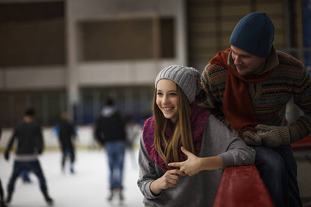 istock Dad and daughter ice skating,indoor 486315437