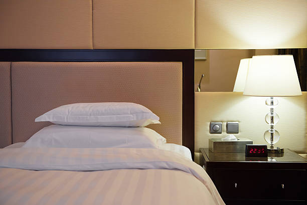 istock bed and lamp in a hotel room 486316414