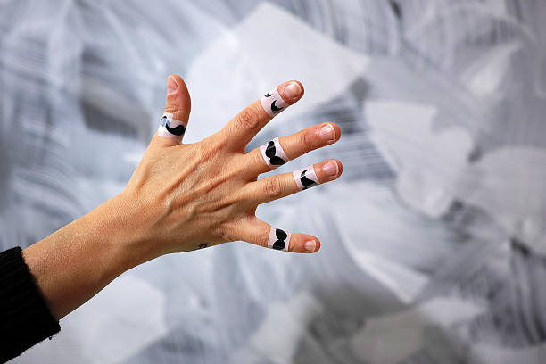 istock Moustache Stickers On Five Fingers Of Hand With Grey Background 486319352