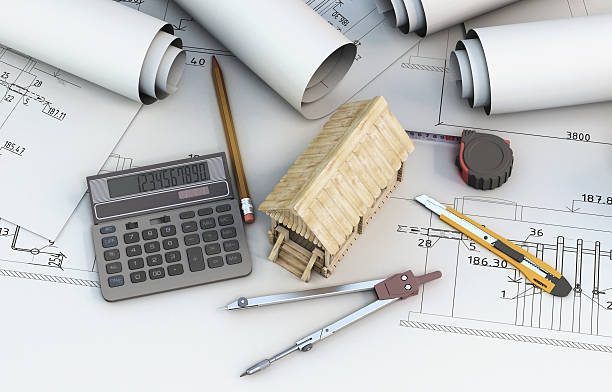 istock Calculator, tools designer and wooden house on projects 486319668