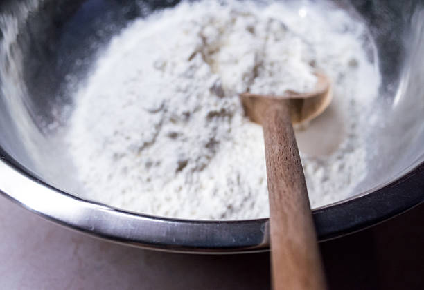 istock Scooping White Flour with a Wooden Spoon 486320570