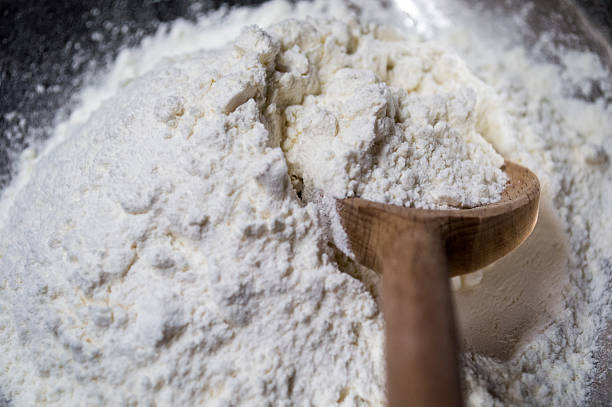 istock Scooping White Flour with a Wooden Spoon Rear View 486320574