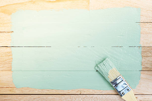 istock Green paint space with paintbrush on wood background 486323984