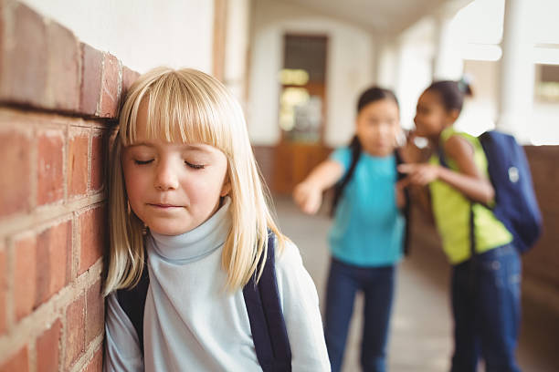 istock Sad pupil being bullied by classmates at corridor 486325334