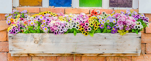 istock Plastic flower in vase on wall background 486326711