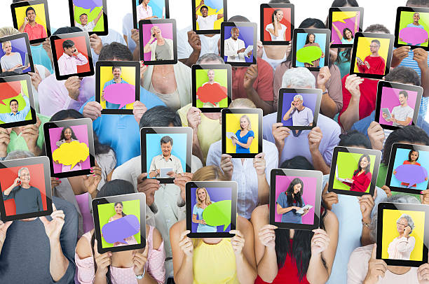 grupo multiétnico de pessoas com tablets em frente - unrecognizable person human face large group of people crowd - fotografias e filmes do acervo