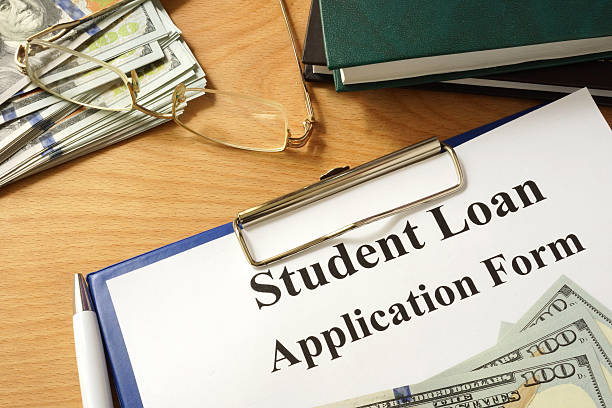 istock Student loan form with dollars and books. 486328624