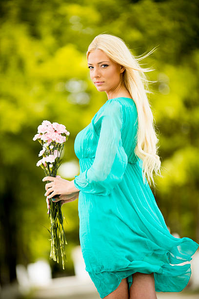 istock Young blond woman with flowers 486328765