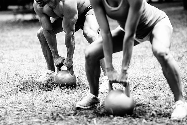 gym couple exercisingt with kettle bell