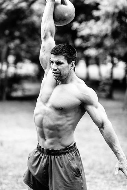 istock gym athlete lifting kettle bell 486329666