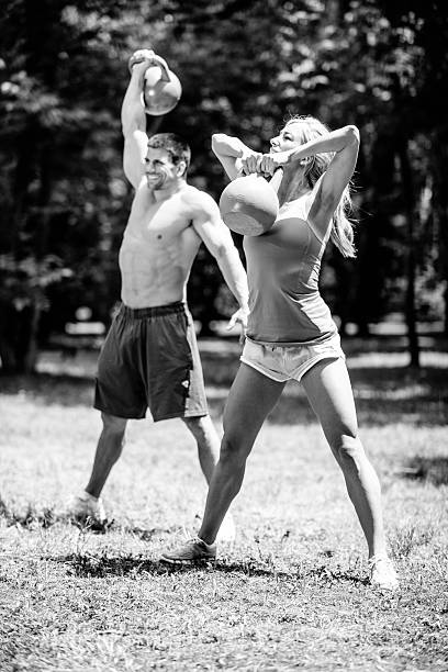 istock Fitness couple exercising with kettle bells 486329682