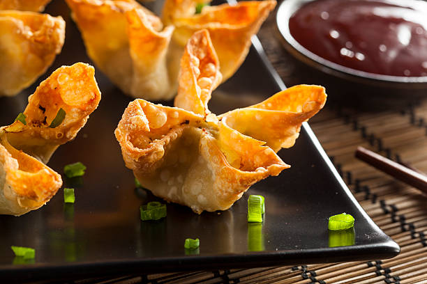 Asian Crab Rangoons with Sweet and Sour Sauce Homemade Asian Crab Rangoons with Sweet and Sour Sauce yangon photos stock pictures, royalty-free photos & images