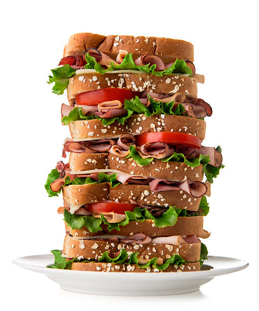 Sandwich Tall sandwich on plate with white background.  Please see my portfolio for other food and drink images.  big plate of food stock pictures, royalty-free photos & images