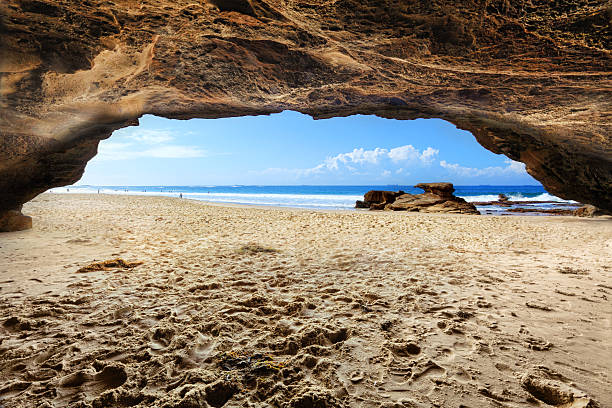 Inside one of the caves at Caves Beach Australia at low tide on a beautiful sunny day  Difficult exposure due to the extreme dynamic range inside the dark cave to sunny outside..  Two exposures