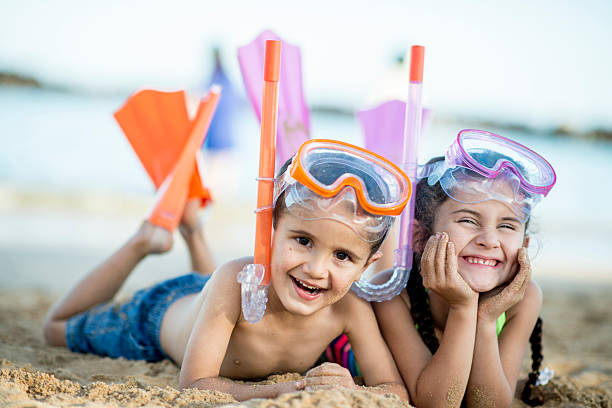 istock Brother and Sister Happily at the Beach 486343572