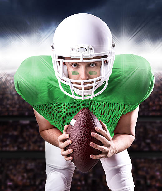 istock Football Player on green uniform in the stadium 486345904