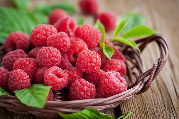 Ripe raspberry with leaf Fresh organic ripe raspberry with leaf in basket, selective focus raspberry stock pictures, royalty-free photos & images