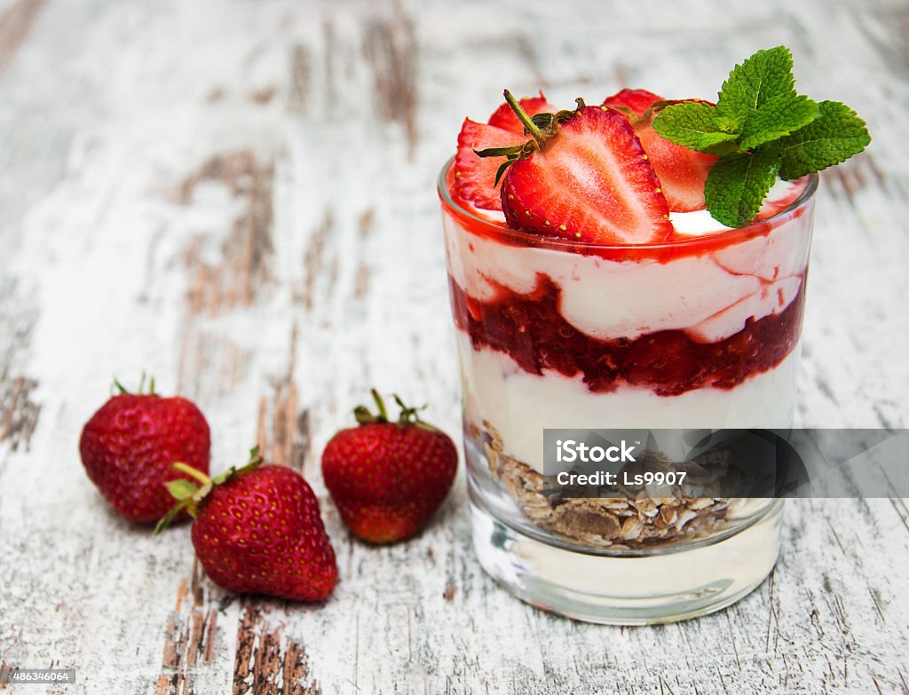 strawberry yogurt with muesli strawberry yogurt with muesli on a old wooden background 2015 Stock Photo