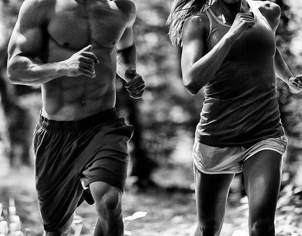 Jogging couple gym athleteic couple jogging chin ups photos stock pictures, royalty-free photos & images