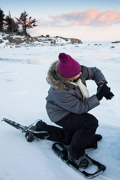 istock Woman checks her fit bit device while snowshoeing 486352710