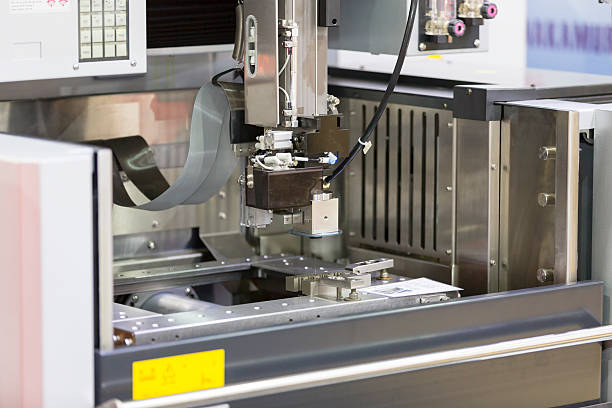 istock CNC wire cut machine cutting mold parts 486352794