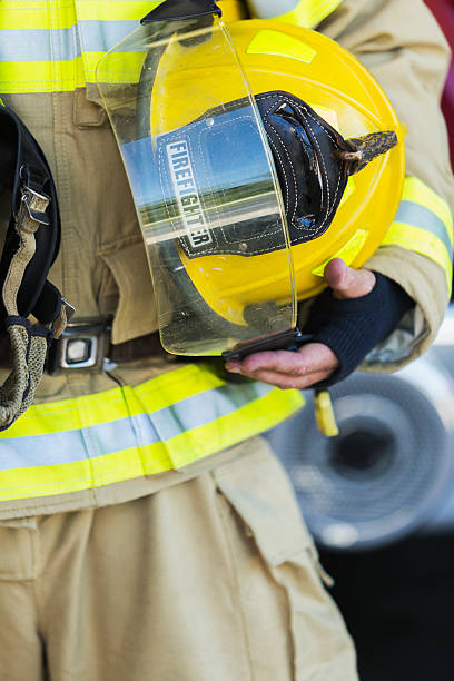 istock Cropped view of fire fighter holding helmet 486353086