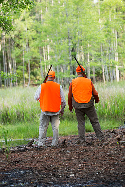 istock Backs of two hunters looking at woods 486353108
