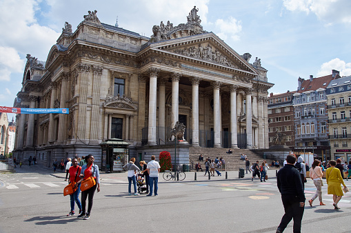 Brussels, Belgium - July 31, 2015: Brussels Stock exchange with people walking in middle of the streets. The center of Brussels is now totally car free.