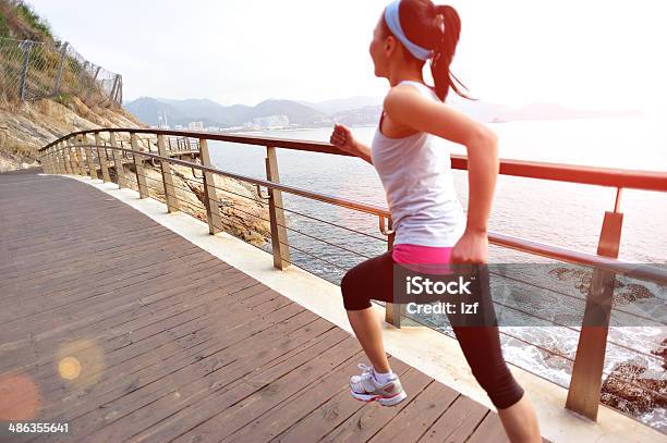 Healthy Lifestyle Asian Woman Running At Wooden Trail Seaside Stock Photo - Download Image Now