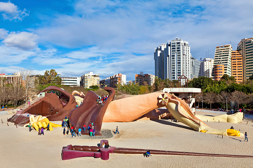 Valencia, Spain - January 14, 2014: Children in Gulliver kids park - popular attraction with 70 meters sculpture of Gulliver which can be accessed via ramps, slides and ladders. Located in Turia Gardens - old river bed in Valencia, Spain.