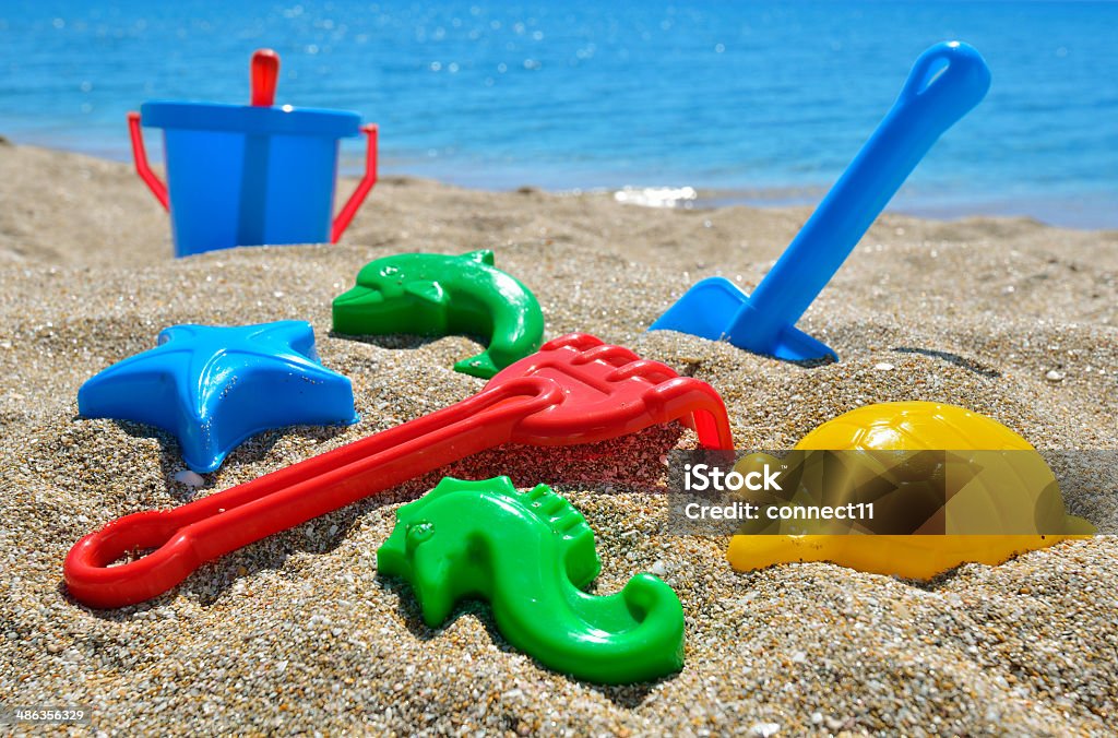 Baby beach toys Baby beach toys on the sand against the blue sea Animal Stock Photo
