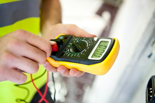 A service technician is using a modern multimeter to test the Voltage .