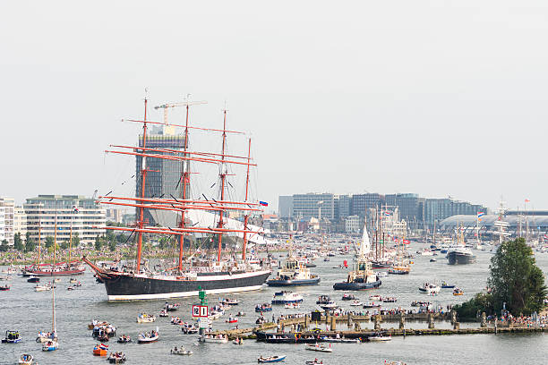 Tall ship Sedov leaving Amsterdam SAIL 2015 Amsterdam, the Netherlands - August 23, 2015: Tall ship STS Sedov leaving Amsterdam after the SAIL 2015 event. Sedov is a four masted tall ship built in 1921 in Germany. Today it sails under the Russian flag. SAIL is the biggest public event in the Netherlands. Famous tall ships visit the city. Small boats are allowed to enter the harbour. krusenstern stock pictures, royalty-free photos & images