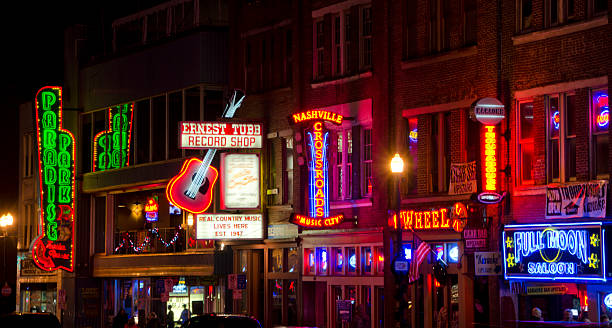 Nightlife in Nashville, Tennessee Nashville, United States - December 10, 2014: The nightlife in downtown Nashville, Tennessee is always hopping, with bars and clubs open well into the early morning hours. tennessee road sign stock pictures, royalty-free photos & images