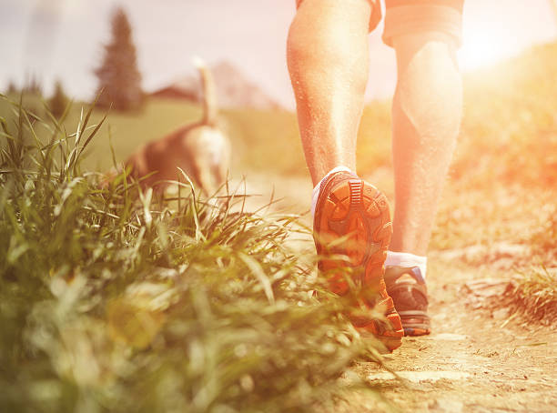 istock Man legs on the mountain footpath close up image 486359754