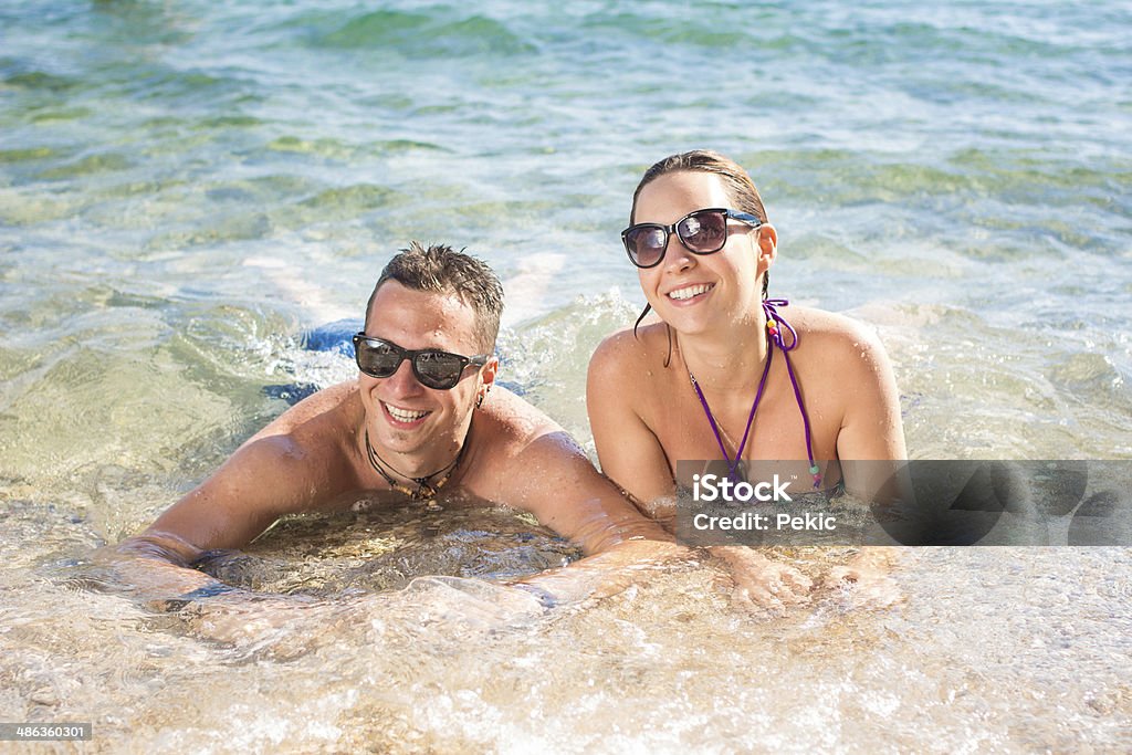 Smiling couple enjoying in water Young couple enjoy in summer vacation Adult Stock Photo