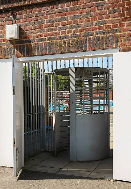 istock Turnstile gate to a Lido - an outside swimming pool. 486360835