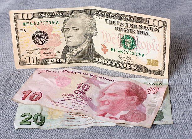 istock Financial crisis: new ten dollars over thirty crumpled turkish liras 486361040