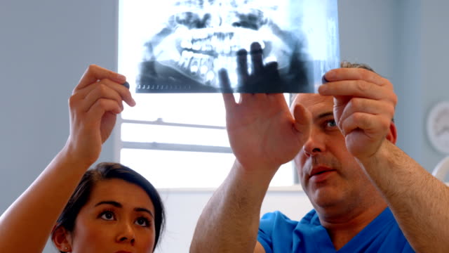 Dentist discussing patients teeth xray