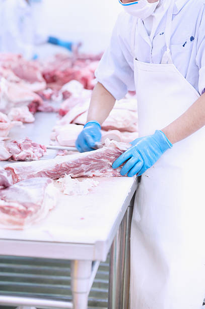 istock butcher cutting meat on the table 486364598