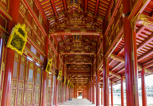 Typical Vietnamese style corridor at The Citadel in The Imperial City of Hue with colorful paintings on beams.