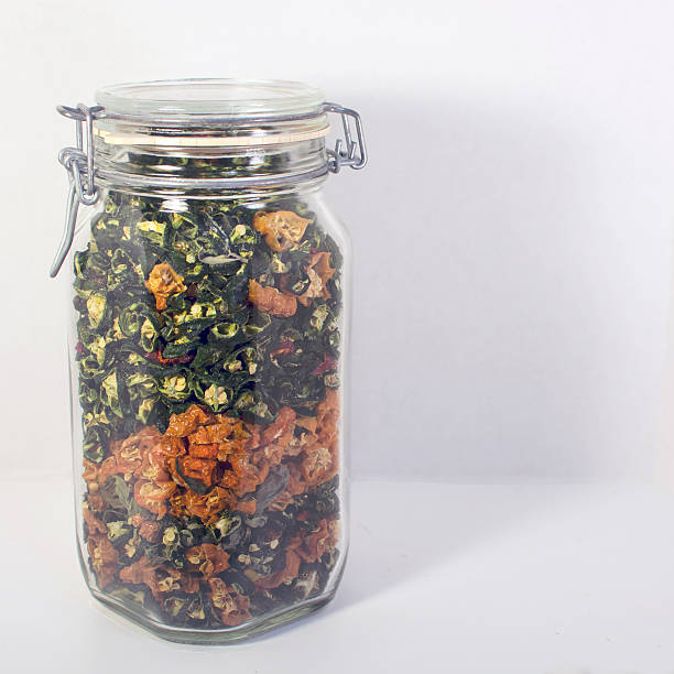 istock Dried hot peppers in a jar on white background 486366314