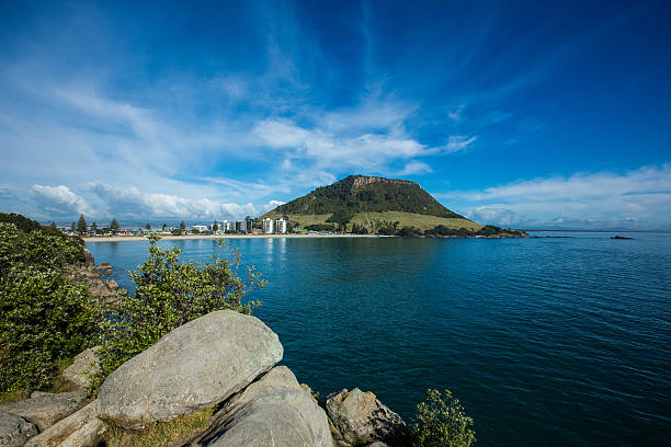 View Of Mount Maunganui across beach Mid day View Of Mount Maunganui across beach, you can see the two towers in the background mount maunganui stock pictures, royalty-free photos & images
