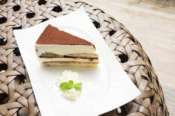 istock tiramisu cake served with whipped cream in the white dish 486368266