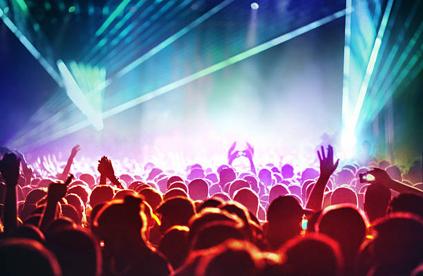 istock People at concert party. 486369304