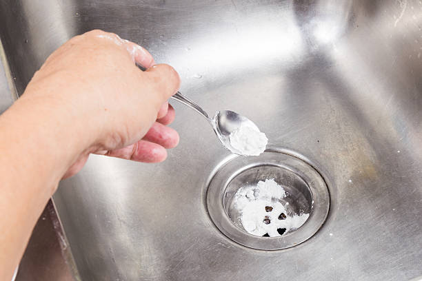 istock Baking soda poured to unclog drainage system at home. 486370360