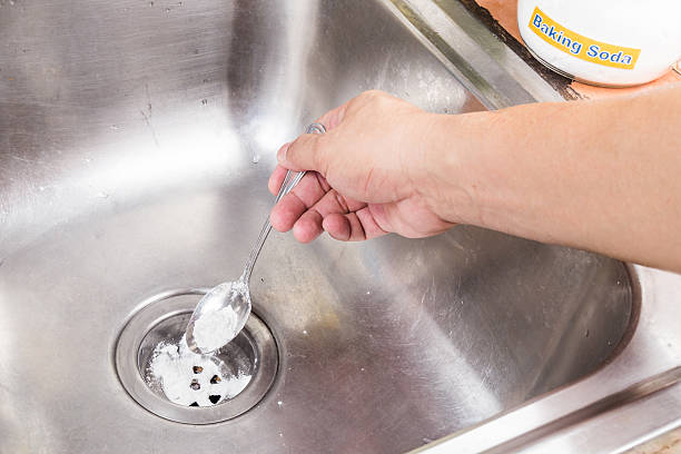 istock Baking soda poured to unclog drainage system at home. 486370362