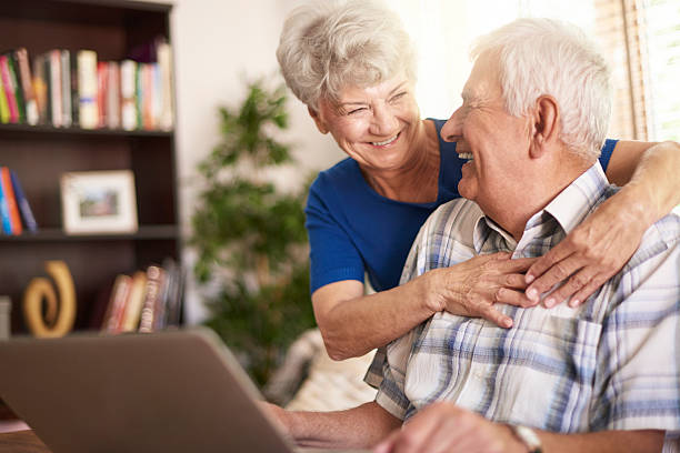 istock Senior marriage using laptop in the living room 486371930