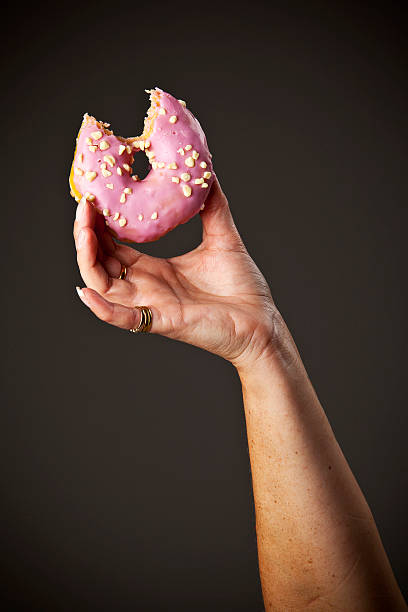 istock Pink donut with bite taken out of it 486373989